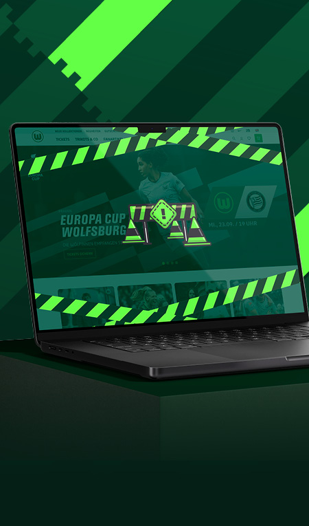 Laptop zeigt eine VfL-Wolfsburg-Webseite zum Europa Cup mit grün-weißer Grafik.
