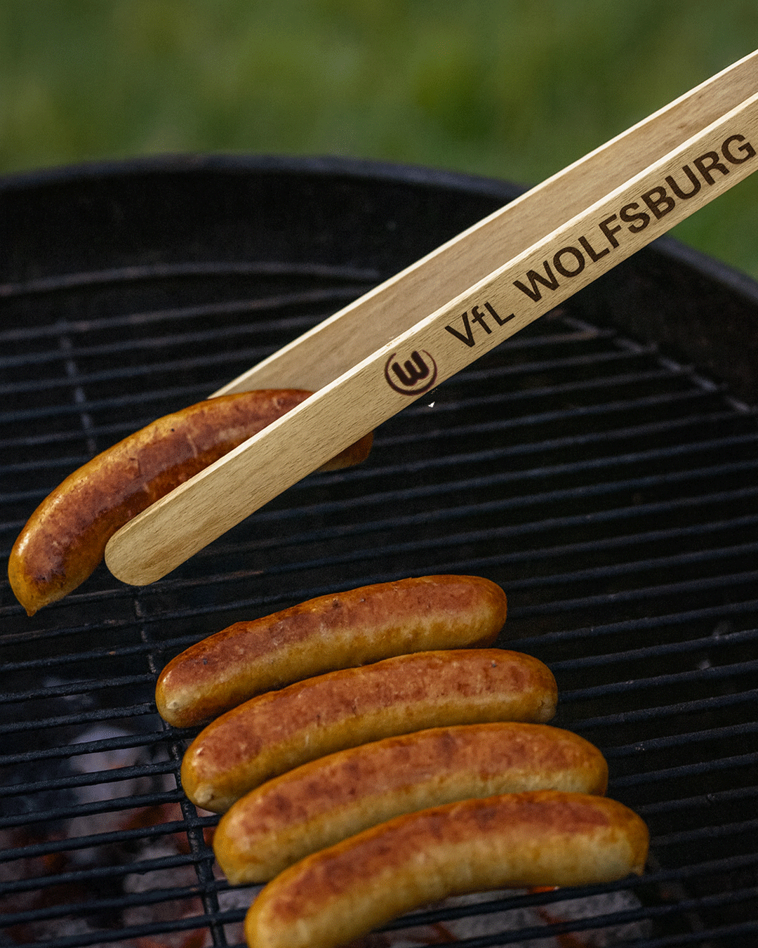 Barbecue tongs with bottle opener