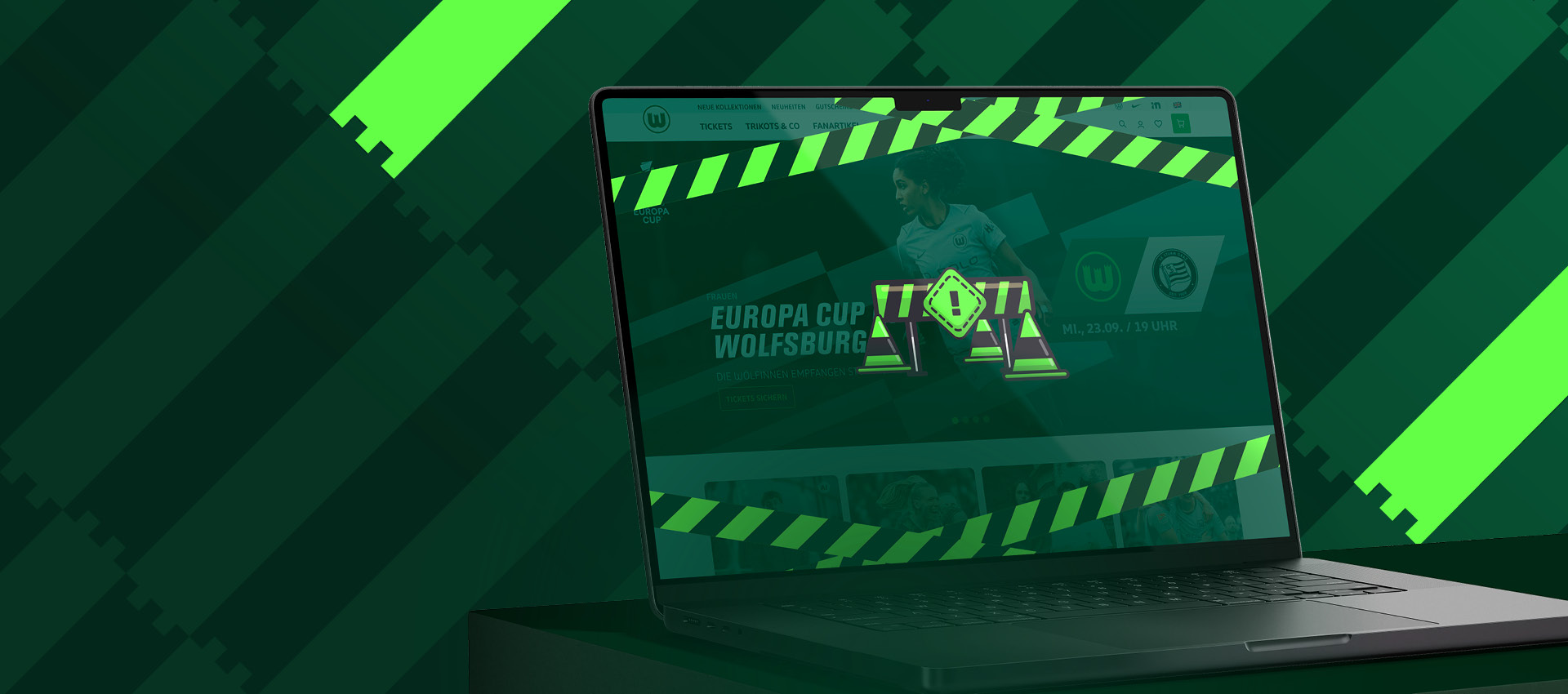Laptop zeigt eine VfL-Wolfsburg-Webseite zum Europa Cup mit grün-weißer Grafik.