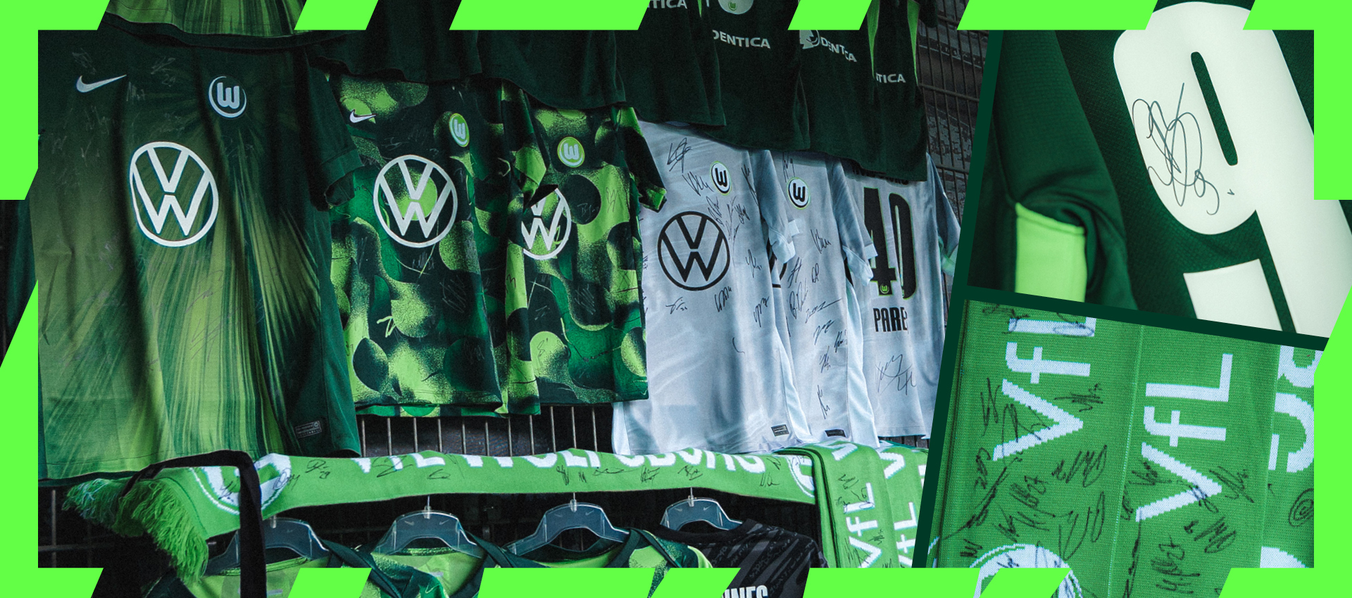 Signierte VfL-Wolfsburg-Trikots und Schals hängen an einem Verkaufsstand.