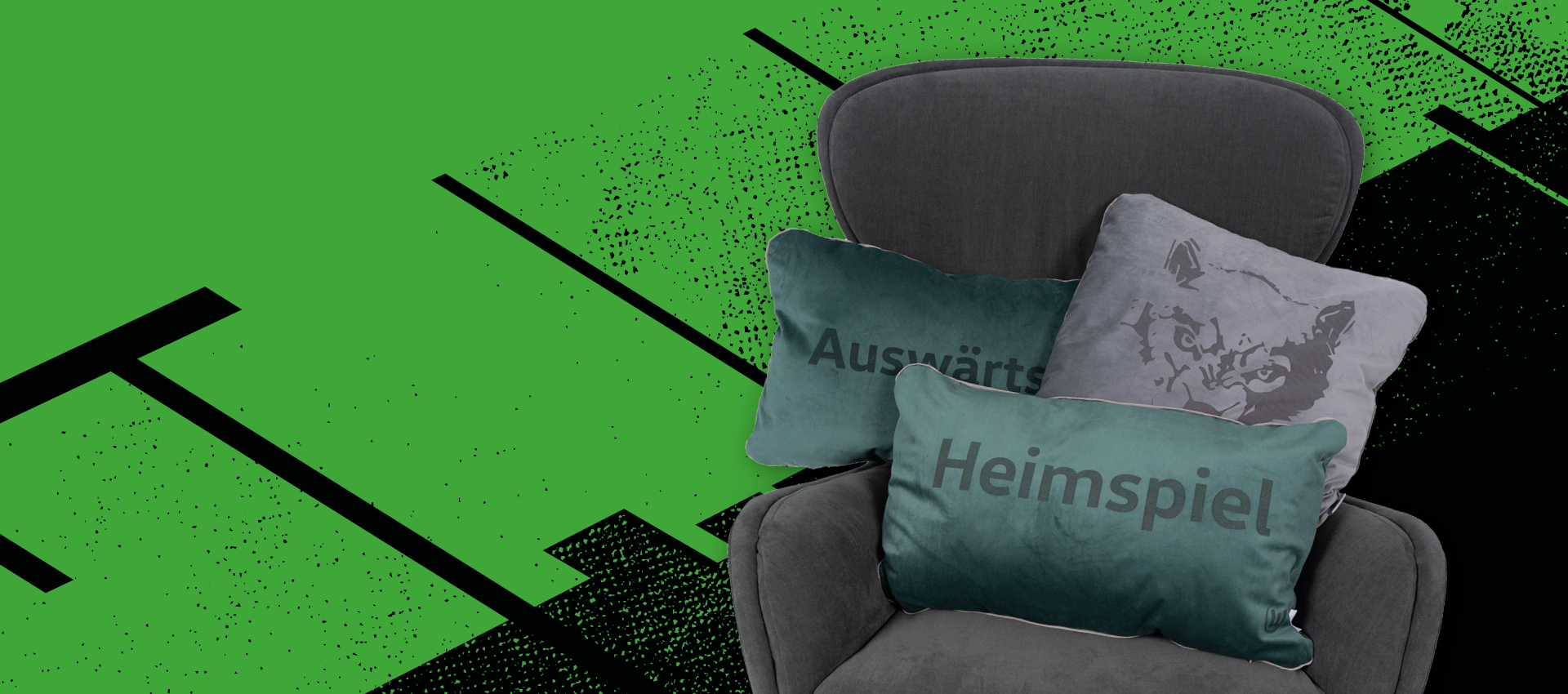 Bewerbungsgrafik Sessel mit drei VfL Wolfsburg Kissen darauf